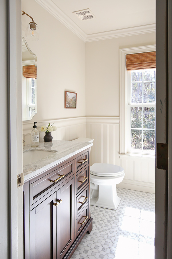 bathroom makeover with beadboard wainscoting, chair rail, marble floors and wood vanity