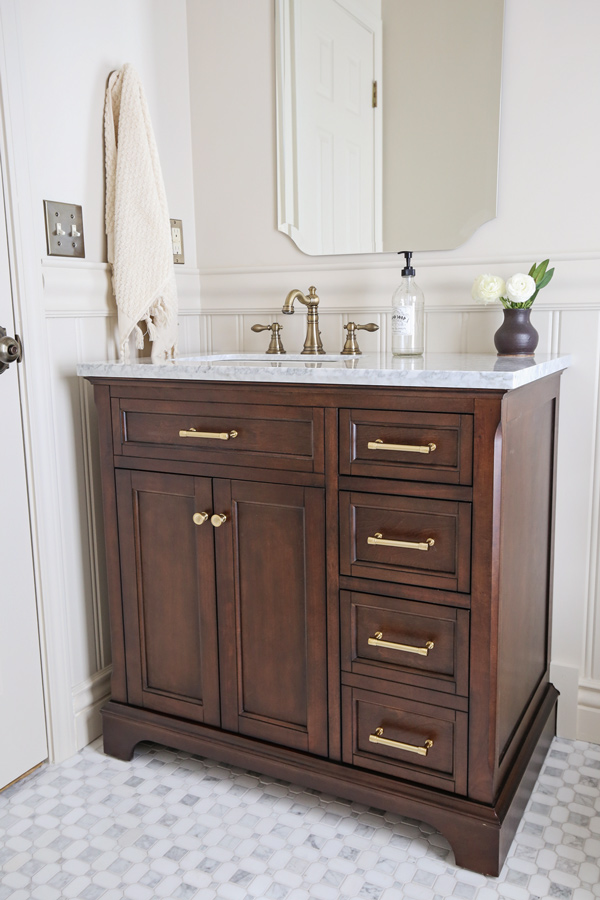 bathroom makeover with beadboard wainscoting, chair rail, marble floors and wood vanity