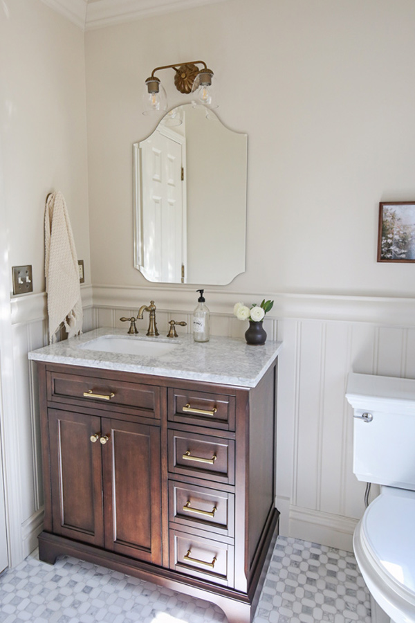 classic, charming bathroom makeover with beadboard wainscoting, chair rail, marble floors and wood vanity