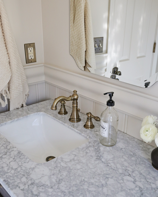 budget friendly vintage look brass faucet in bathroom on marble sink top