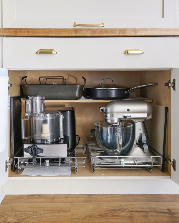 kitchen gadget cord organizer on mixer and food processor in kitchen cabinet
