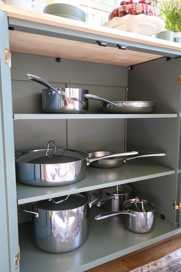mobile kitchen cart with extra storage - inside of cabinets with pot and pan set