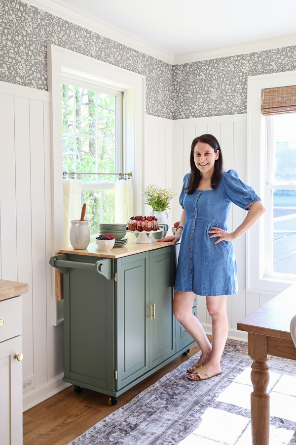 mobile kitchen cart in dining room with cake and dishes on it for entertaining