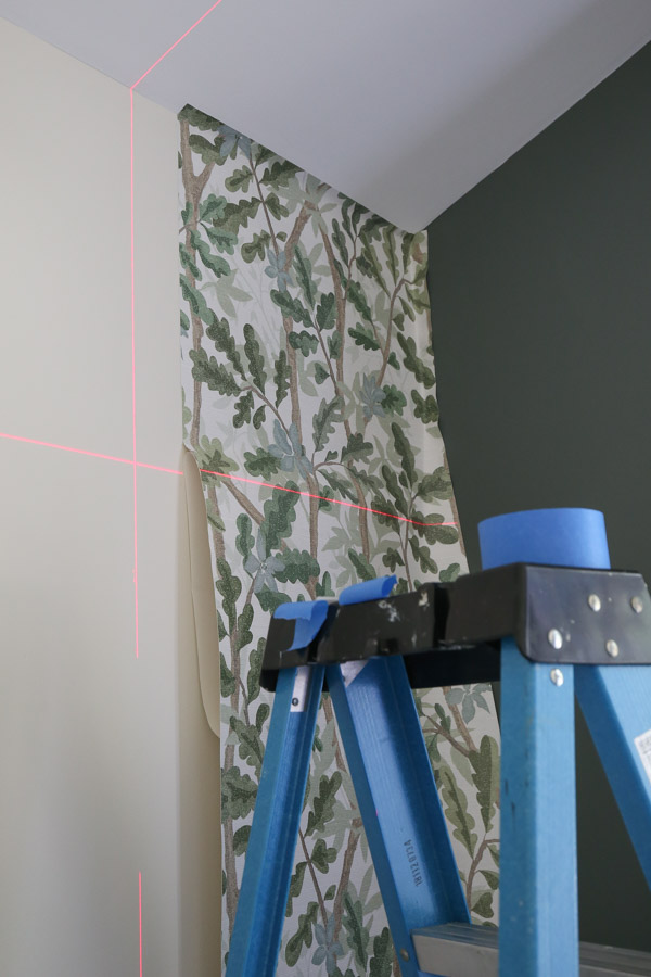 installing woodland tree peel and stick full wall wallpaper on boy bedroom wall