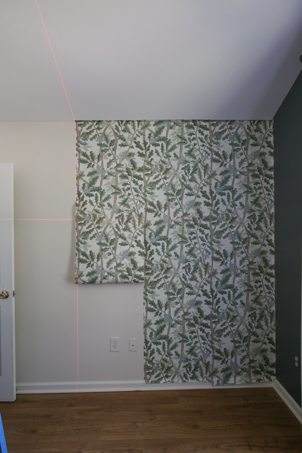 installing woodland tree peel and stick full wall wallpaper on boy bedroom wall