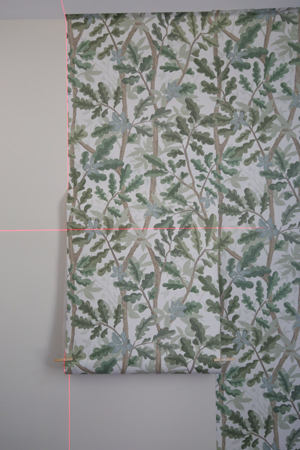 installing woodland tree peel and stick full wall wallpaper on boy bedroom wall