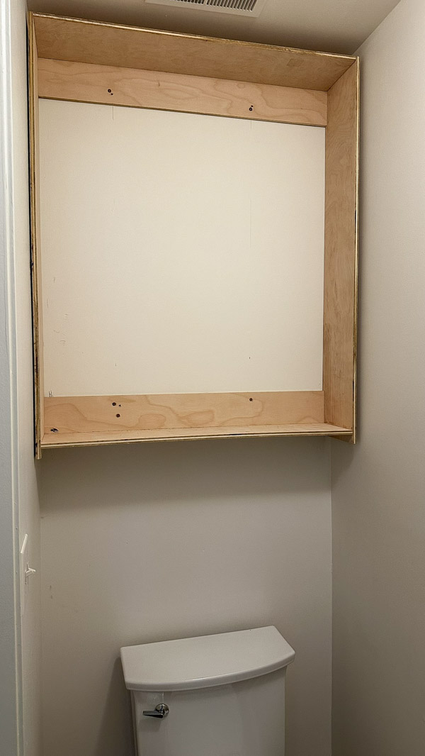 building over the toilet storage cabinet in water closet
