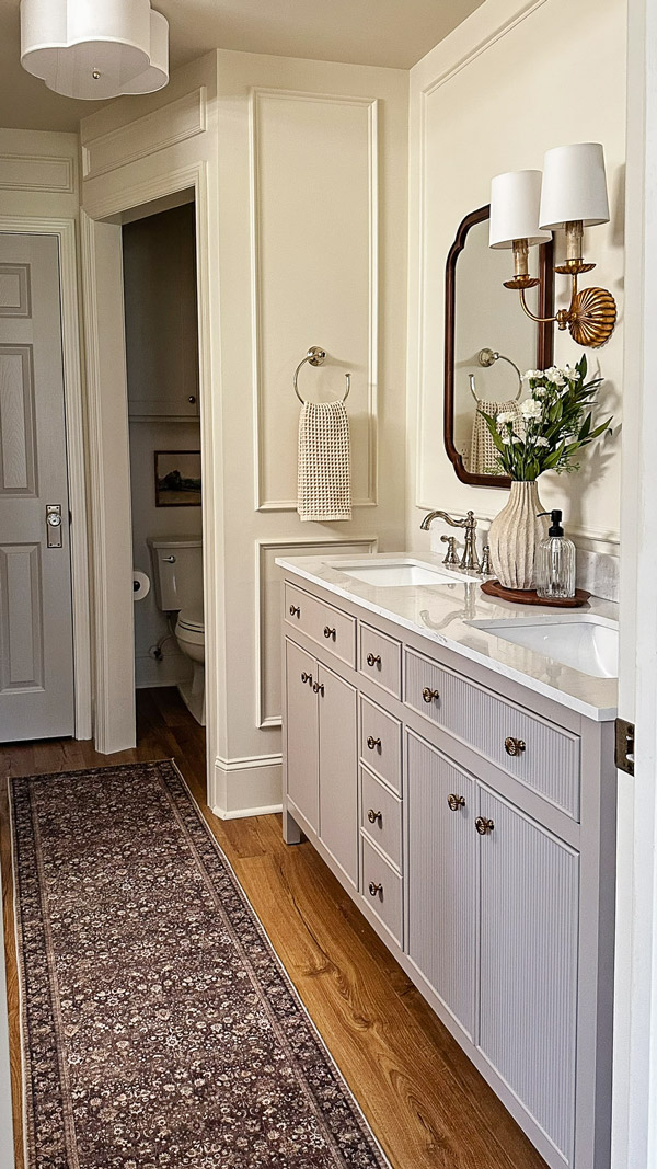 primary bathroom makeover with flush mount ceiling light and regina andrew clove wall sconce