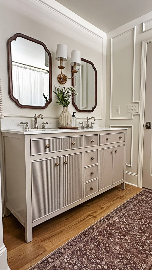 timeless, charming, classic, vintage look bathroom makeover with double wall sconce, and wood arch mirrors and polished nickel faucet