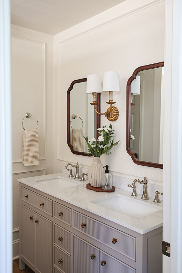 makeover with double vanity, wood arch mirrors, and picture frame molding