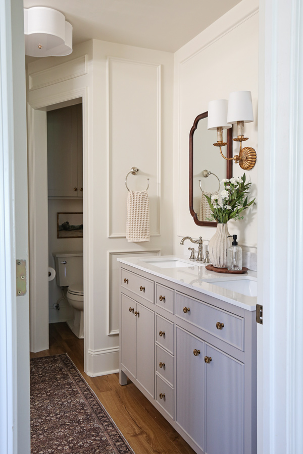 makeover with double vanity, wood arch mirrors, and picture frame molding