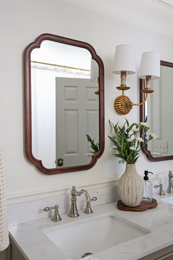 timeless, charming, classic, vintage look bathroom makeover with double wall sconce, and wood arch mirrors and polished nickel faucet