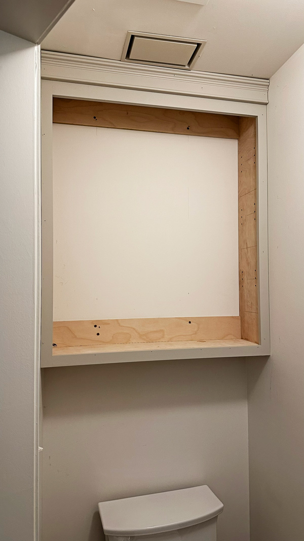building over the toilet storage cabinet in water closet