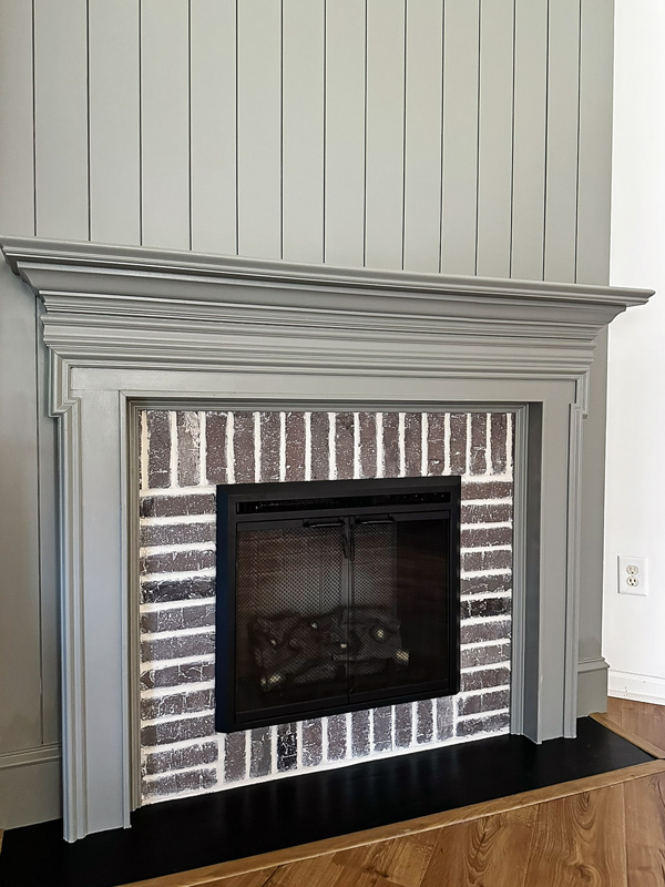 vertical shiplap fireplace and brick fireplace DIY with brick veneer and over-grouted look or German schmear