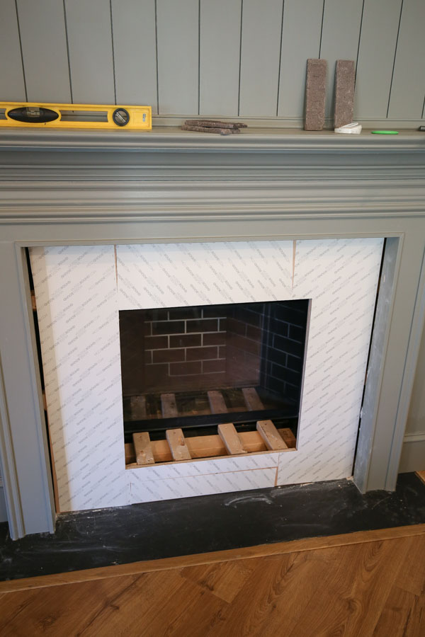 using musselbound adhesive tile mat for DIY brick fireplace