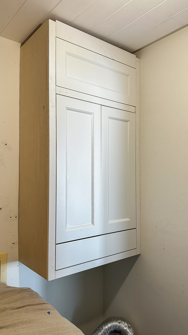 stacked cabinet in laundry room. diy built in wall cabinet
