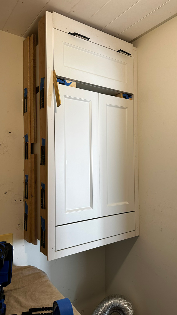 stacked cabinet in laundry room. diy built in wall cabinet