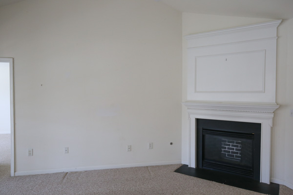 before living room makeover - builder grade and stained white carpet and white walls