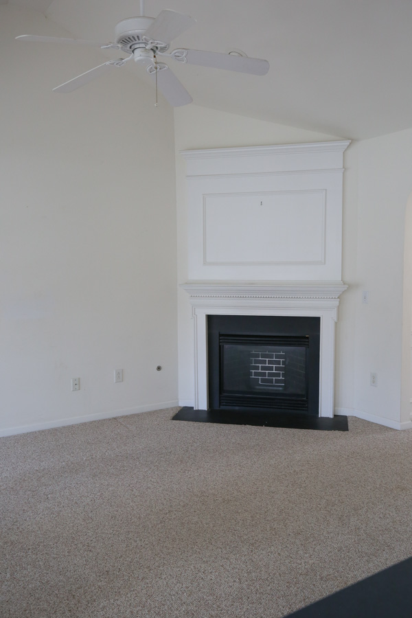 before living room makeover - builder grade and stained white carpet and white walls