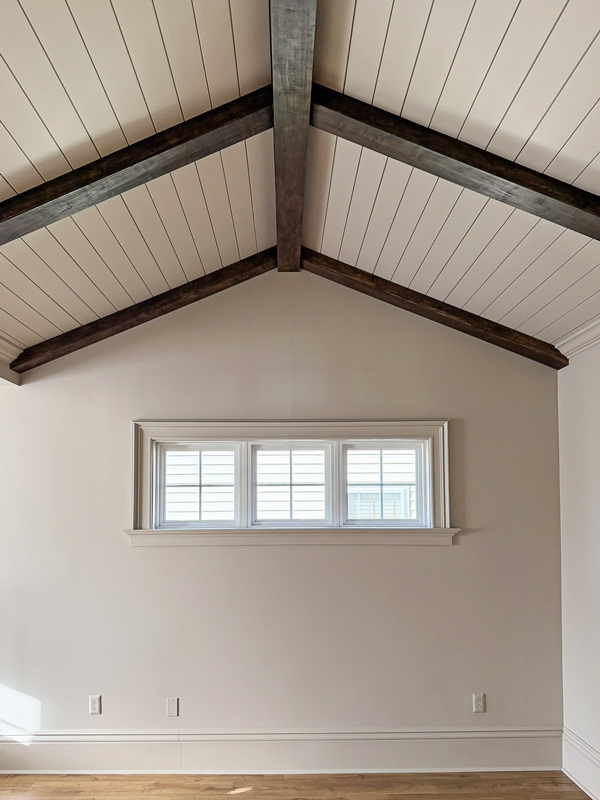 primary bedroom makeover - how we added character to our builder grade bedroom with architectural details, wood beams, vaulted ceiling with shiplap