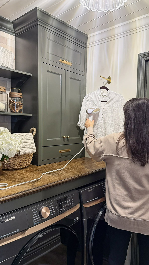 steaming shirt on fold down wall hook in Laundry Room Organization Ideas with Charm and Function